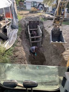 Trench digging by Inland Trenchless replacing faulty side sewer. Inland Trenchless image.